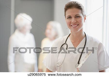 Stock Photography - Portrait of nurse in retirement community. Fotosearch