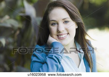 Stock Photo - Portrait of teenage girl in park. Fotosearch