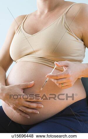 Pregnant woman injecting belly View Large Photo Image Stock Photo - Pregnant woman injecting belly. Fotosearch
