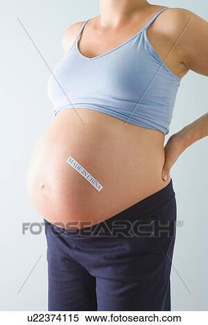 Pregnant woman with label on belly View Large Photo Image Stock Photography - Pregnant woman with label on belly. Fotosearch