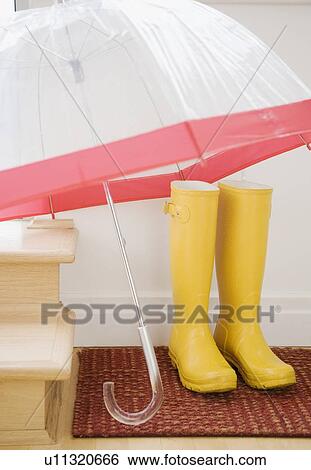 Rain boots and umbrella drying indoors View Large Photo Image Stock Photograph - Rain boots and umbrella drying indoors. Fotosearch