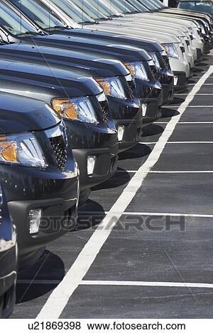 Row of cars in car lot View Large Photo Image Stock Photo - Row of cars in car lot. Fotosearch