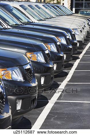 Row of cars in car lot View Large Photo Image Stock Photo - Row of cars in car lot. Fotosearch