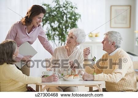 Senior adults eating dinner View Large Photo Image Stock Photo - Senior adults eating dinner. Fotosearch