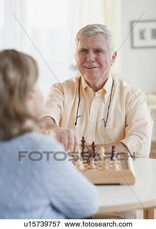 Stock Photo - Senior couple playing chess. Fotosearch