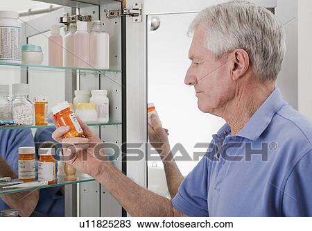 Senior man looking at prescription View Large Photo Image Stock Image - Senior man looking at prescription. Fotosearch