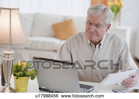 Senior man paying bills online View Large Photo Image Stock Photograph - Senior man paying bills online. Fotosearch