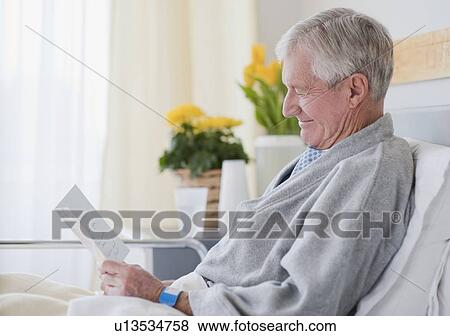 Senior man reading get well card in hospital View Large Photo Image Stock Photo - Senior man reading get well card in hospital. Fotosearch