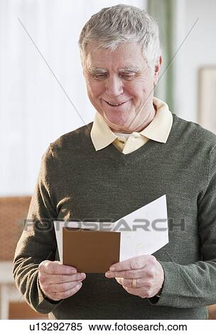 Senior man reading greeting card View Large Photo Image Stock Photography - Senior man reading greeting card. Fotosearch