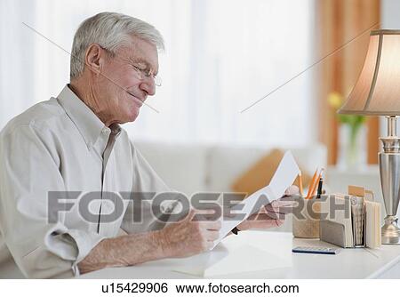 Senior man reading letter View Large Photo Image Stock Photograph - Senior man reading letter. Fotosearch