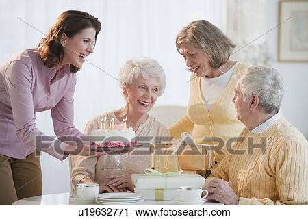 Stock Image - Senior woman celebrating birthday. Fotosearch