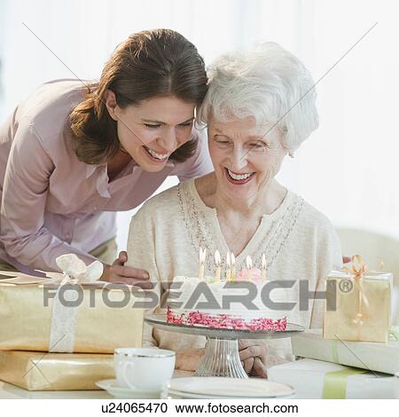 Stock Image - Senior woman celebrating birthday. Fotosearch