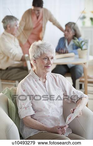 Senior woman reading greeting card View Large Photo Image Stock Photo - Senior woman reading greeting card. Fotosearch