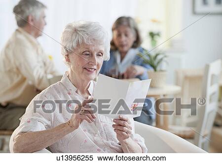 Senior woman reading greeting card View Large Photo Image Stock Photography - Senior woman reading greeting card. Fotosearch