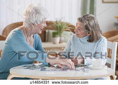 Senior women assembling puzzle View Large Photo Image Stock Image - Senior women assembling puzzle. Fotosearch