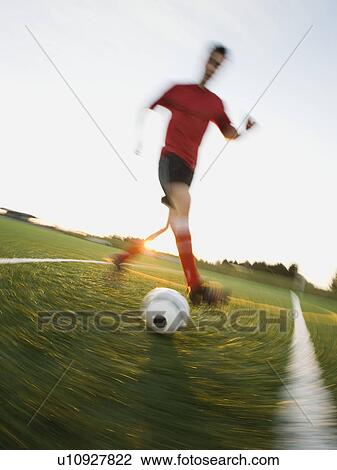 Soccer player dribbling ball View Large Photo Image Stock Image - Soccer player dribbling ball. Fotosearch