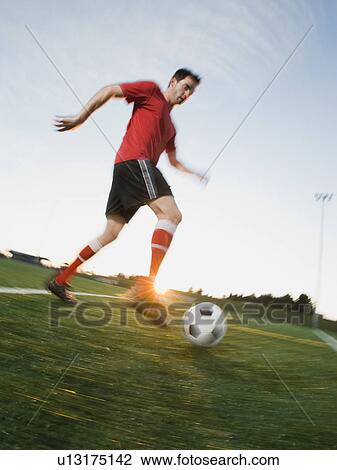 Soccer player dribbling ball View Large Photo Image Stock Image - Soccer player dribbling ball. Fotosearch