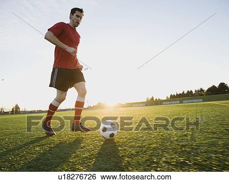 Soccer player dribbling ball View Large Photo Image Stock Photograph - Soccer player dribbling ball. Fotosearch