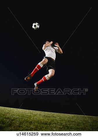 Stock Photo - Soccer player heading ball. Fotosearch