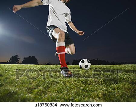 Picture - Soccer player kicking ball. Fotosearch