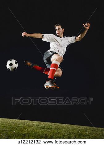 Soccer player kicking ball View Large Photo Image Stock Image - Soccer player kicking ball. Fotosearch