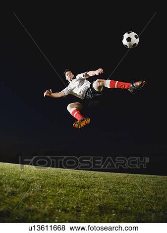 Soccer player kicking ball View Large Photo Image Stock Photo - Soccer player kicking ball. Fotosearch