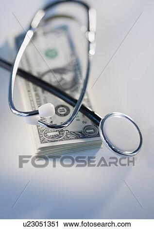 Stack of money and stethoscope View Large Photo Image Stock Image - Stack of money and stethoscope. Fotosearch