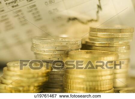 Stock Photo - Stacks of euro coins and exchange rates. Fotosearch