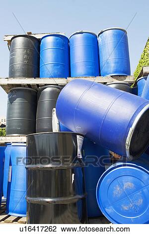 Stock Image - Stacks of toxic waste barrels. Fotosearch