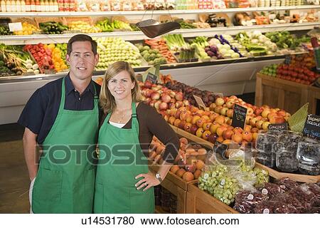 Store owners posing in produce section View Large Photo Image Stock Image - Store owners posing in produce section. Fotosearch