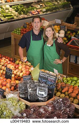 Store owners posing in produce section View Large Photo Image Stock Image - Store owners posing in produce section. Fotosearch
