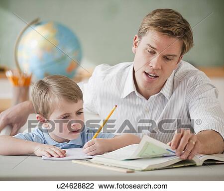 Teacher helping student with homework View Large Photo Image Stock Image - Teacher helping student with homework. Fotosearch