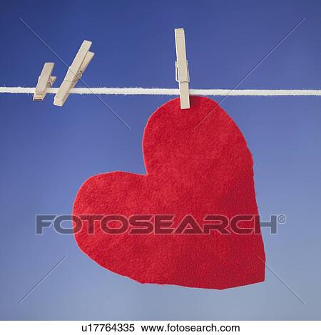 Stock Photography - Teddy bear and bib drying on clothesline. Fotosearch