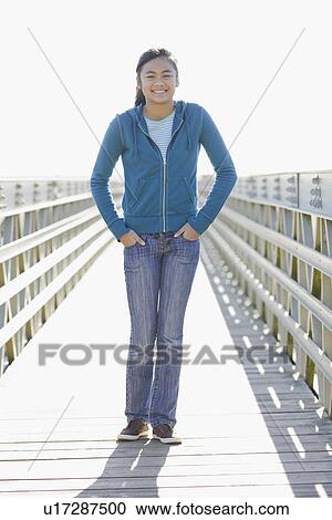 Teenage girl standing on dock View Large Photo Image Stock Image - Teenage girl standing on dock. Fotosearch