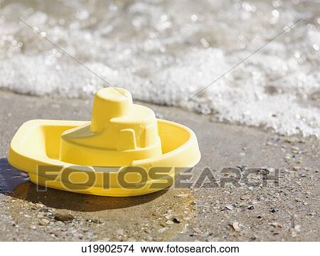 Picture - Toy boat on beach. Fotosearch