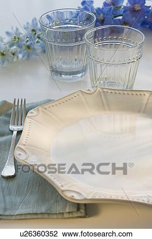 Stock Image - Tropical flowers and placesetting. Fotosearch