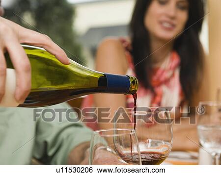 Waiter pouring wine in restaurant View Large Photo Image Stock Photograph - Waiter pouring wine in restaurant. Fotosearch