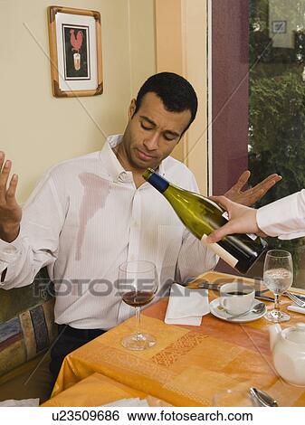 Waiter spilling wine on customer View Large Photo Image Stock Photograph - Waiter spilling wine on customer. Fotosearch