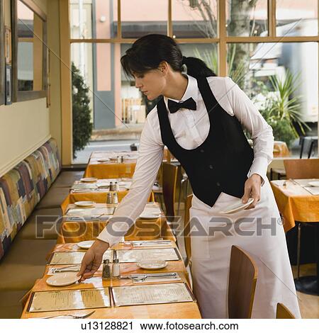 Waitress setting restaurant tables View Large Photo Image Stock Image - Waitress setting restaurant tables. Fotosearch