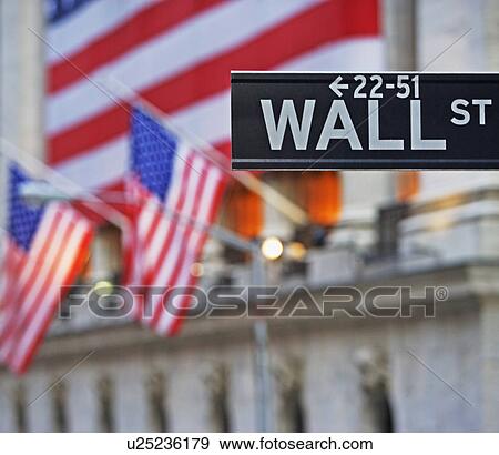 Stock Photo - Wall Street sign and American flags. Fotosearch