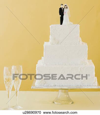Stock Image - Wedding cake toppers on cake. Fotosearch