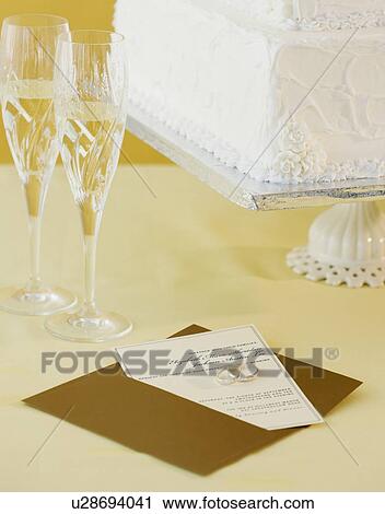 Stock Image - Wedding invitation and cake. Fotosearch