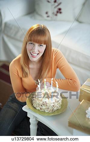 Woman celebrating birthday with cake View Large Photo Image Picture - Woman celebrating birthday with cake. Fotosearch