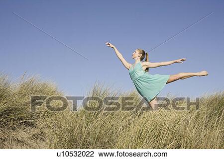 Woman dancing on sand dunes View Large Photo Image Stock Image - Woman dancing on sand dunes. Fotosearch