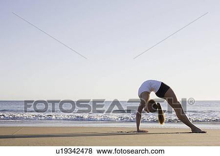 Woman doing yoga on beach View Large Photo Image Stock Photo - Woman doing yoga on beach. Fotosearch