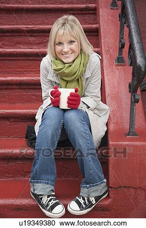 Woman drinking hot chocolate on front stoop View Large Photo Image Stock Image - Woman drinking hot chocolate on front stoop. Fotosearch