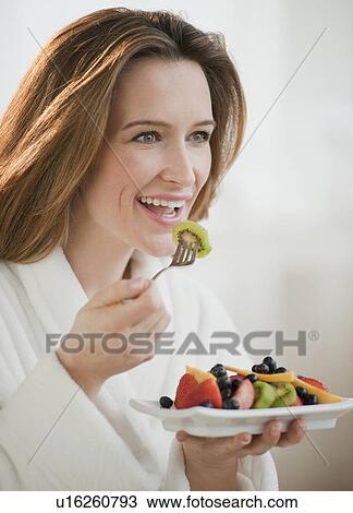 Woman eating fresh fruit View Large Photo Image Stock Image - Woman eating fresh fruit. Fotosearch