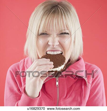 Woman eating ice cream sandwich View Large Photo Image Stock Image - Woman eating ice cream sandwich. Fotosearch