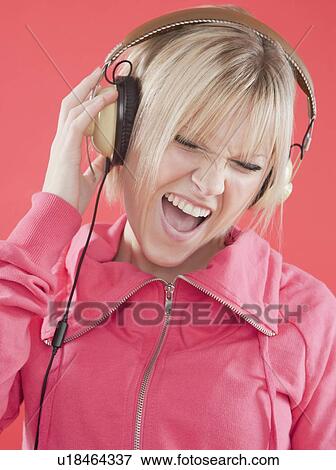 Stock Photo - Woman eating ice cream sandwich. Fotosearch