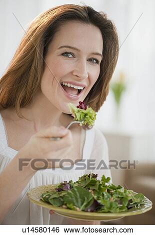 Woman eating salad View Large Photo Image Stock Photograph - Woman eating salad. Fotosearch